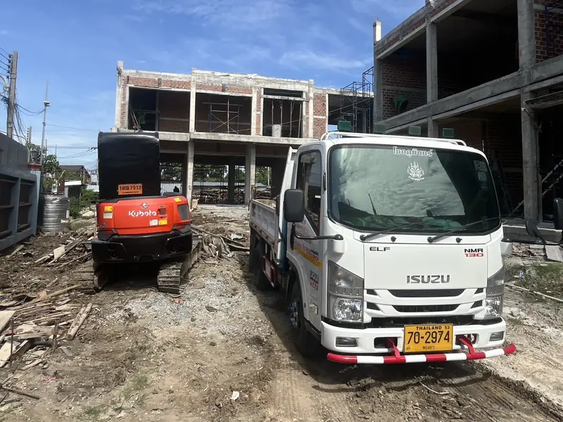 รถบรรทุกและรถขุดทำงานร่วมกับงานก่อสร้างในไซต์